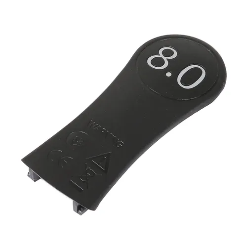 Black plastic replacement lever for a hair clipper with two attachment prongs at one end and safety certification symbols on the surface.