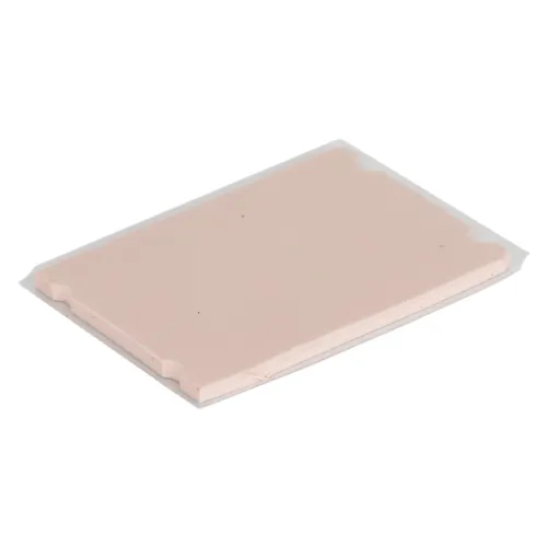A thin, rectangular thermal pad in a peach colour with slightly raised edges, resting flat on a white surface.