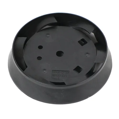 Round black plastic component with several holes and slots, possibly a mounting base or cover for an electronic or mechanical device, placed on a white background.