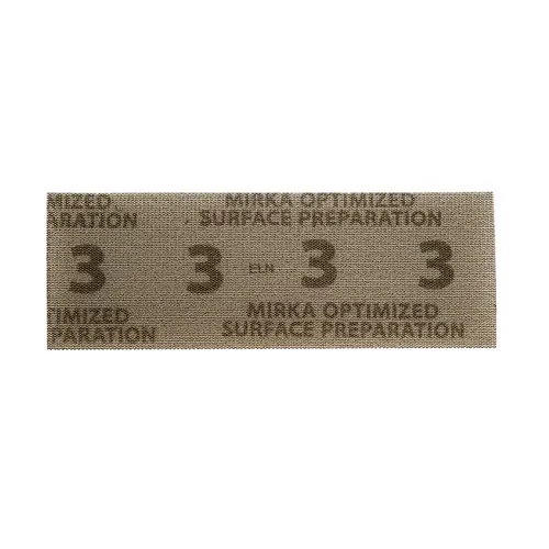 A rectangular strip of sandpaper on a beige background.