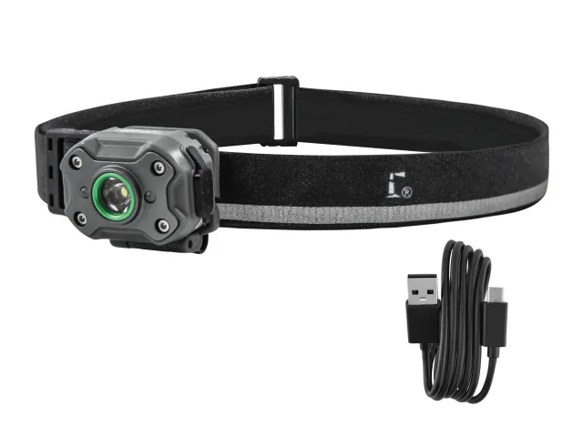 A black headtorch with a green lens is attached to an adjustable strap. Beside it lies a coiled USB charging cable featuring both a USB-A and micro USB connector.