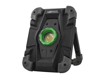 A rugged, black portable work light with a green circular light in the centre, sturdy corners, and a foldable stand.