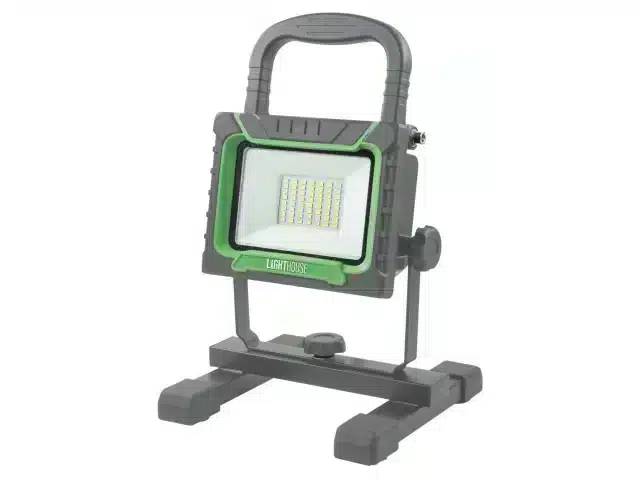 Portable LED work light with a handle and adjustable stand, featuring a green and grey frame and a rectangular front with multiple LED bulbs, placed on a white background.