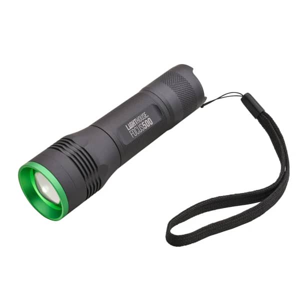 A black torch featuring a green rim around its lens and a black wrist strap attached to the end, resting on a white background.