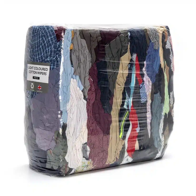 A large, clear plastic-wrapped bundle containing assorted, crumpled, multicoloured cotton fabric pieces—no denim included—ideal for efficient cleaning tasks.