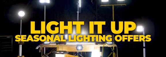 Several bright work lights are arranged around a table in a dark room.
