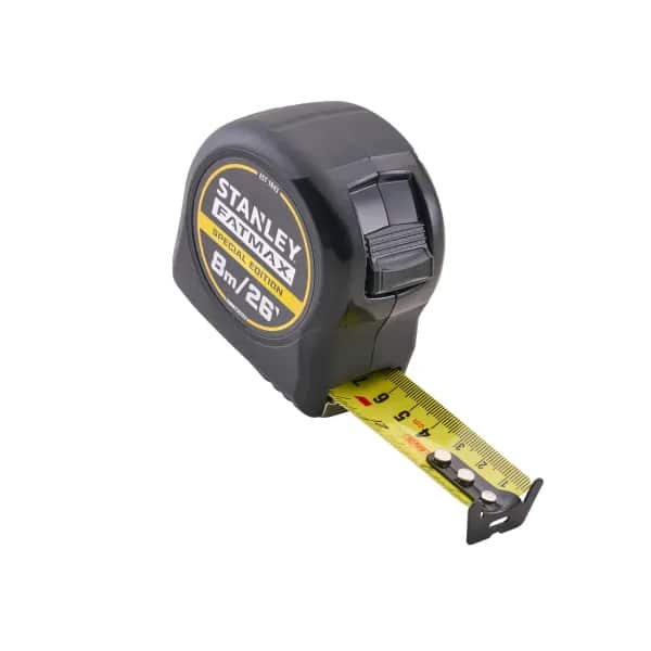A black Stanley FatMax tape measure with yellow tape extended, displaying inch and centimetre markings. The tape measures up to 8 metres or 26 feet.